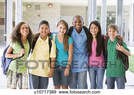 Stock Photo - Six students standing outside school together smiling. Fotosearch