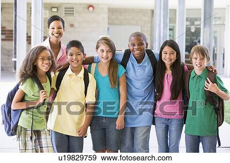 Six students standing outside school with teacher View Large Photo Image Stock Photo - Six students standing outside school with teacher. Fotosearch