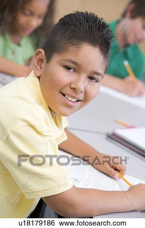Stock Photograph - Student in class taking notes (selective focus). Fotosearch