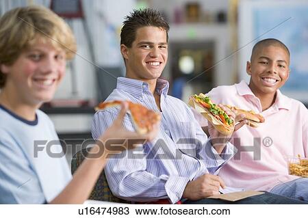 Stock Image - Students having lunch. Fotosearch