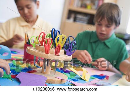Stock Photograph - Students in art class with supplies in foreground (selective focus). Fotosearch