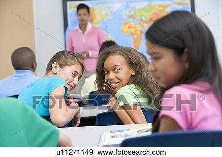 Students in class bullying student with teacher in background (selective focus) View Large Photo Image Stock Photo - Students in class bullying student with teacher in background (selective focus). Fotosearch