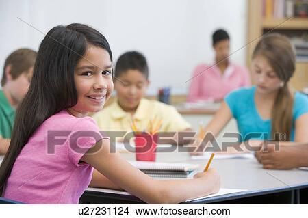 Students in class taking notes with teacher in background (selective focus) View Large Photo Image Picture - Students in class taking notes with teacher in background (selective focus). Fotosearch