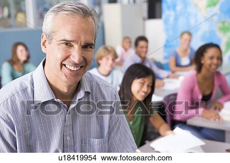 Picture - Students studying in geography class with teacher. Fotosearch