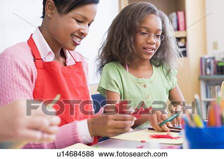 Teacher and student in art class (selective focus) View Large Photo Image Stock Photo - Teacher and student in art class (selective focus). Fotosearch