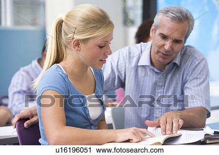 Stock Image - Teacher giving personal instruction to female student. Fotosearch