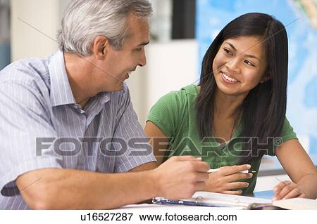 Stock Photo - Teacher giving personal instruction to female student. Fotosearch