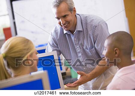 Teacher with students in computer class View Large Photo Image Stock Image - Teacher with students in computer class. Fotosearch