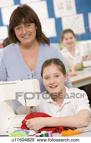 Female student using sewing machine with teacher View Large Photo Image Stock Photo - Female student using sewing machine with teacher. Fotosearch