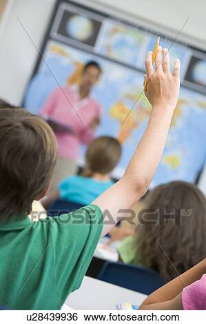 Student volunteering in geography class for teacher (selective focus) View Large Photo Image Stock Photograph - Student volunteering in geography class for teacher (selective focus). Fotosearch