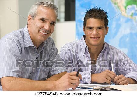 Stock Photo - Teacher giving personal instruction to male student. Fotosearch
