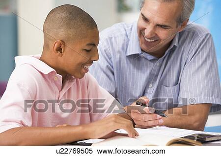 Teacher giving personal instruction to male student View Large Photo Image Stock Photography - Teacher giving personal instruction to male student. Fotosearch