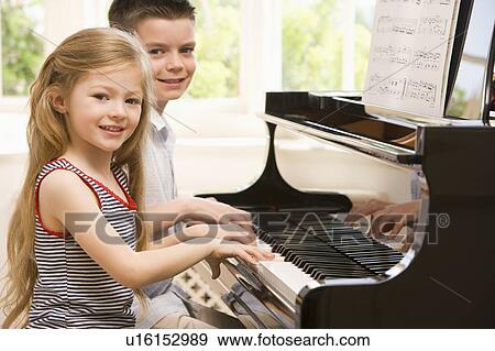Stock Photo - Brother And Sister Playing Piano. Fotosearch