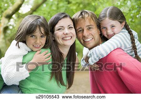 Stock Image - Family outdoors smiling. Fotosearch