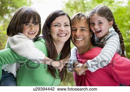 Stock Image - Family outdoors smiling. Fotosearch