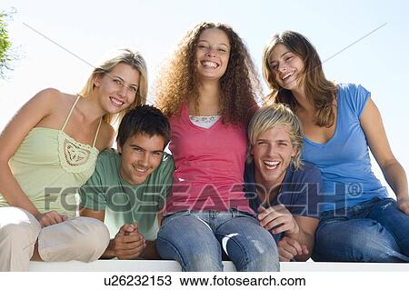 Stock Image - Five people on balcony smiling. Fotosearch