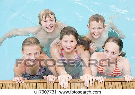 Five young friends in swimming pool smiling View Large Photo Image Stock Image - Five young friends in swimming pool smiling. Fotosearch
