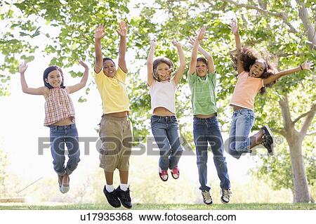 Five young friends jumping outdoors smiling View Large Photo Image Stock Photo - Five young friends jumping outdoors smiling. Fotosearch