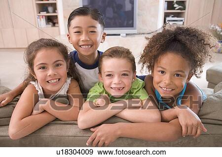Stock Photo - Four Young Friends Hanging Out At Home. Fotosearch