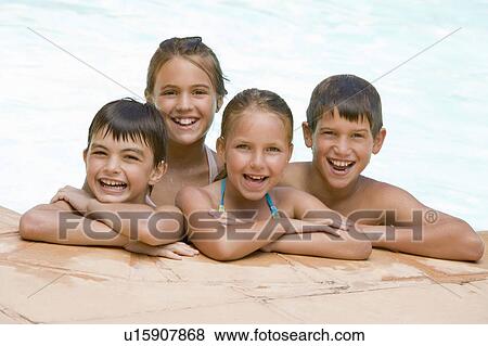 Four young friends in swimming pool smiling View Large Photo Image Stock Photo - Four young friends in swimming pool smiling. Fotosearch