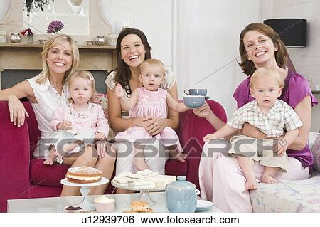 Three mothers in living room with babies and coffee smiling View Large Photo Image Stock Photograph - Three mothers in living room with babies and coffee smiling. Fotosearch