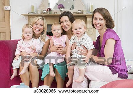 Three mothers in living room with babies smiling View Large Photo Image Stock Photograph - Three mothers in living room with babies smiling. Fotosearch