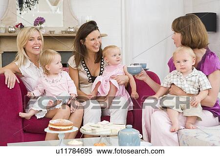 Three mothers in living room with babies and coffee smiling View Large Photo Image Stock Photography - Three mothers in living room with babies and coffee smiling. Fotosearch