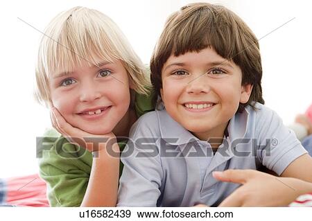 Two Young Boys Lying Down On A Bed View Large Photo Image Stock Photo - Two Young Boys Lying Down On A Bed. Fotosearch