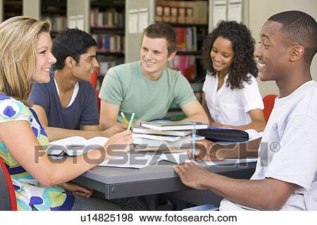 Stock Photo - Five people in library studying (selective focus). Fotosearch