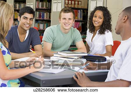 Stock Photograph - Five people in library studying (selective focus). Fotosearch