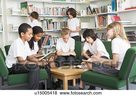 Seven students in library reading books View Large Photo Image Stock Photo - Seven students in library reading books. Fotosearch