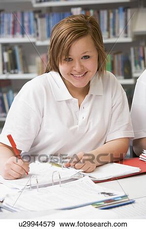 Stock Photo - Student writing and studying. Fotosearch