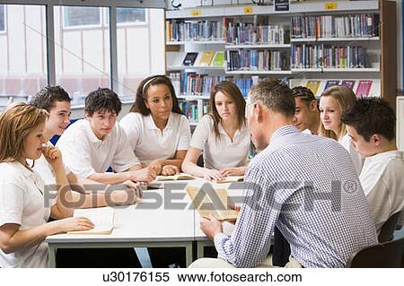 Stock Photography - Students and teacher in a study group collaborating. Fotosearch