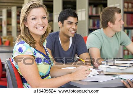 Three people in library studying (selective focus) View Large Photo Image Picture - Three people in library studying (selective focus). Fotosearch