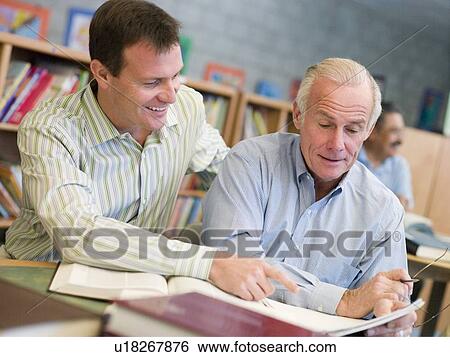 Two men in library talking (selective focus) View Large Photo Image Stock Photograph - Two men in library talking (selective focus). Fotosearch