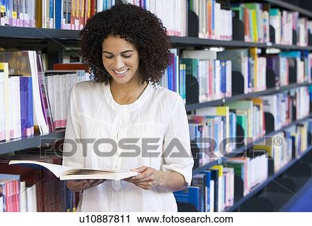 Woman in library reading book (depth of field) View Large Photo Image Stock Image - Woman in library reading book (depth of field). Fotosearch