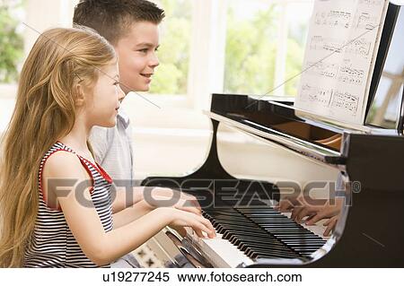 Brother And Sister Playing Piano View Large Photo Image Stock Photography - Brother And Sister Playing Piano. Fotosearch