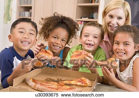 Four young children indoors with woman eating pizza smiling View Large Photo Image Stock Photography - Four young children indoors with woman eating pizza smiling. Fotosearch