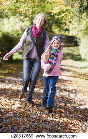Grandmother and granddaughter running outdoors in park and smiling View Large Photo Image Stock Photo - Grandmother and granddaughter running outdoors in park and smiling. Fotosearch
