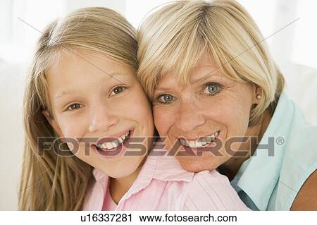 Stock Image - Grandmother and granddaughter smiling. Fotosearch