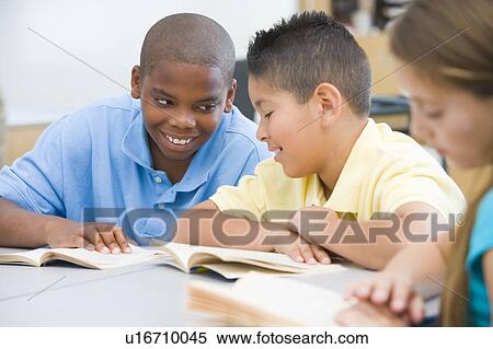 Stock Photography - Students in class reading together (selective focus). Fotosearch