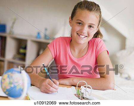 Stock Photo - Young Girl Doing Her Homework. Fotosearch