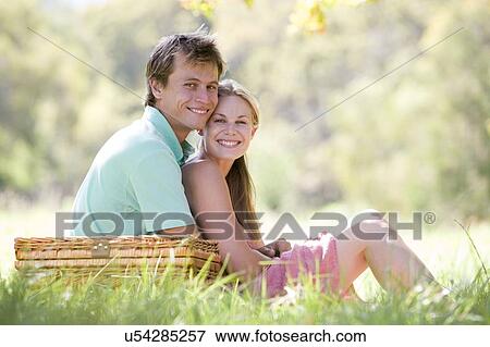 Couple at park having a picnic and smiling View Large Photo Image Stock Photo - Couple at park having a picnic and smiling. Fotosearch