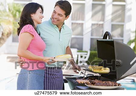 Stock Photo - Couple Cooking On A Barbeque. Fotosearch