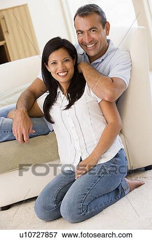 Couple in living room smiling View Large Photo Image Stock Photo - Couple in living room smiling. Fotosearch