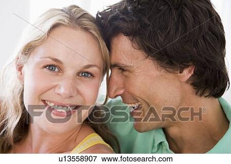 Couple in living room smiling View Large Photo Image Stock Photo - Couple in living room smiling. Fotosearch