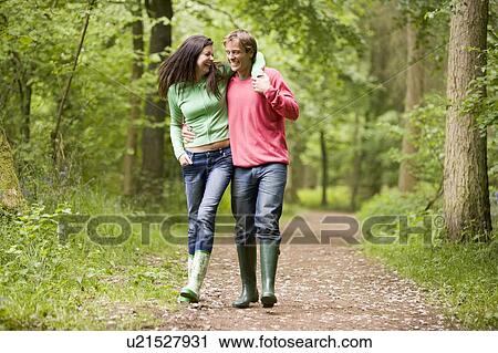 Couple walking on path arm in arm View Large Photo Image Stock Image - Couple walking on path arm in arm. Fotosearch