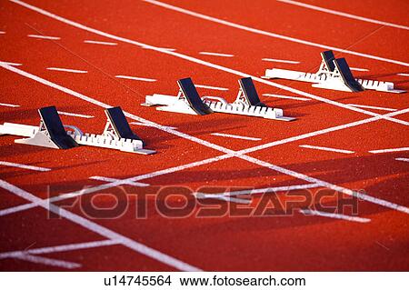 Picture - Close-up of three sets of track starting block on the running track. Fotosearch