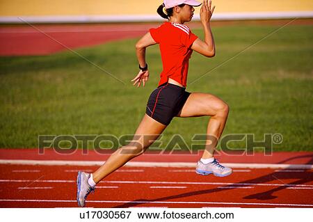 Female athlete running on race track View Large Photo Image Stock Photo - Female athlete running on race track. Fotosearch