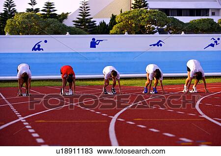 Five female athletes in starting positions on running track View Large Photo Image Stock Image - Five female athletes in starting positions on running track. Fotosearch